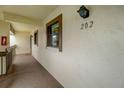 Condo hallway with carpeted floors and a fire extinguisher at 2400 Winding Creek Blvd # 3-202, Clearwater, FL 33761