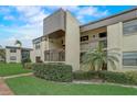 Condo building exterior showcasing a two-story design and landscaping at 2400 Winding Creek Blvd # 3-202, Clearwater, FL 33761