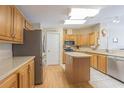 Kitchen features light wood cabinets, granite countertops, and stainless steel appliances at 37532 New Horizons Blvd, Zephyrhills, FL 33541