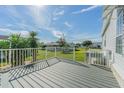 Composite deck overlooks a grassy backyard and neighboring homes at 37532 New Horizons Blvd, Zephyrhills, FL 33541