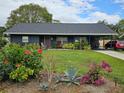 Well-manicured lawn and colorful flowering bushes accent this lovely single Gathering home at 1006 39Th W Ave, Bradenton, FL 34205