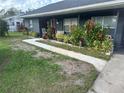 A beautifully landscaped front yard with colorful flowers adds to this home's charm at 1006 39Th W Ave, Bradenton, FL 34205