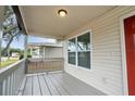 Front porch with gray railings and red door at 3721 Wiggins Leaf St, Tampa, FL 33619