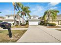 Two-story house with light blue exterior and a white garage door at 12950 Fennway Ridge Dr, Riverview, FL 33579