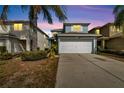 Two-story house with a white garage door and light blue exterior at 12950 Fennway Ridge Dr, Riverview, FL 33579