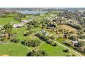 Aerial view of a farmhouse near a baseball field and a lake at 32552 Railroad Ave, San Antonio, FL 33576