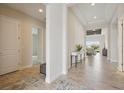 Hallway with tile floors, white walls, and access to other rooms, creating a bright and inviting space at 17721 Roost Pl, Lakewood Ranch, FL 34211
