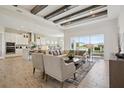 Open concept living room showcasing elegant furniture, wood-look tile floors, and a beautiful view of the backyard at 17721 Roost Pl, Lakewood Ranch, FL 34211