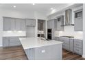 Modern kitchen island with white quartz countertop and gray cabinets at 17725 Roost Pl, Lakewood Ranch, FL 34211