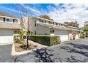 Two story townhome with attached garage and manicured landscaping at 2923 W Gandy Blvd, Tampa, FL 33611