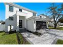 Modern two-story home showcasing a black garage door and an inviting front entrance at 2355 Bahia Vista St, Sarasota, FL 34239