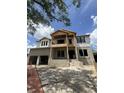 Under construction, the home features a two-story design with a balcony, large windows, and an attached two-car garage at 567 Luzon Ave, Tampa, FL 33606