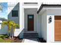 Inviting entryway featuring a modern front door, well-manicured landscaping, and charming front porch at 2365 Bahia Vista St, Sarasota, FL 34239