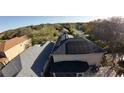 House with solar panels on the roof and a covered patio at 4754 Whispering Wind Ave, Tampa, FL 33614