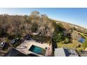 Home with pool, spa, and gazebo; surrounded by lush trees and landscape at 4754 Whispering Wind Ave, Tampa, FL 33614
