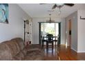 Combined living and dining area with hardwood floors and ample natural light at 10911 Hachita Dr, Port Richey, FL 34668