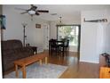 Combined living and dining area with hardwood floors and ample natural light at 10911 Hachita Dr, Port Richey, FL 34668