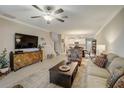 Open living room with comfortable seating and a large TV at 31396 Cabana Rye Ave, San Antonio, FL 33576