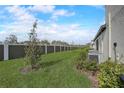 Landscaped backyard with a privacy fence and AC units at 31396 Cabana Rye Ave, San Antonio, FL 33576