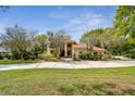 Two-story house with red tile roof and a large yard at 5359 Saddlebrook Way, Wesley Chapel, FL 33543