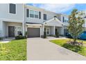 Modern two-story townhouse with gray siding and landscaping at 9658 Sweetwell Pl, Riverview, FL 33569