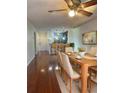 Dining room with hardwood floors, large table, and view into kitchen at 4115 Chatham Oak Ct # 218, Tampa, FL 33624