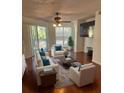 Spacious living room with hardwood floors, comfy furniture, and large TV at 4115 Chatham Oak Ct # 218, Tampa, FL 33624