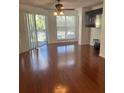 Bright living room with hardwood floors and large windows at 4115 Chatham Oak Ct # 218, Tampa, FL 33624