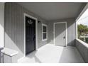 Bright front porch with black and gray doors and white floor at 3007 Dixie Ave, Sarasota, FL 34234