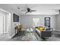 Living room features gray sofa, coffee table, and gray wood-look floors at 3007 Dixie Ave, Sarasota, FL 34234