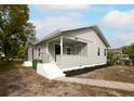 Well-maintained home with gray siding, landscaping, and a walkway at 3007 Dixie Ave, Sarasota, FL 34234