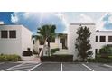 Exterior view of condo building with parking and lush landscaping at 5038 Marsh Field Rd # 18, Sarasota, FL 34235