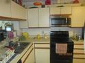 Bright kitchen features ample counter space and a microwave at 2424 W Tampa Bay Blvd # L202, Tampa, FL 33607