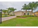 Single-story home with landscaped yard and driveway at 1519 Emerald Dunes Dr, Sun City Center, FL 33573