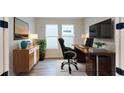 Modern home office features a large desk and plenty of natural light at 3659 Tea Leaf Aly, Land O Lakes, FL 34638