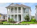 Two-story home with light blue exterior and a front porch at 3659 Tea Leaf Aly, Land O Lakes, FL 34638