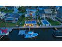 Elevated view of a house with a pool, dock, and boat in a waterfront community at 3357 Mangrove Dr, Hernando Beach, FL 34607