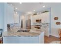 Modern kitchen with granite countertops and stainless steel appliances at 406 Islebay Dr, Apollo Beach, FL 33572