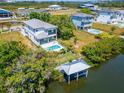 Aerial view of a waterfront home with private dock and pool at 548 Estuary Shore Ln, Apollo Beach, FL 33572