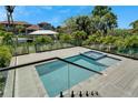 Modern pool and spa with glass railings and composite decking at 548 Estuary Shore Ln, Apollo Beach, FL 33572
