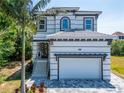 Two-story house with gray and white exterior, and a paved driveway at 548 Estuary Shore Ln, Apollo Beach, FL 33572