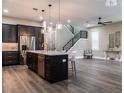 Open kitchen featuring a spacious island, stainless steel appliances, and stylish pendant lighting at 213 W Giddens Ave, Tampa, FL 33603