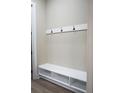 Mudroom features a built-in bench with storage and coat hooks for organization at 213 W Giddens Ave, Tampa, FL 33603