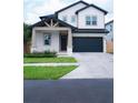 Two-story craftsman style home with gray siding at 213 W Giddens Ave, Tampa, FL 33603