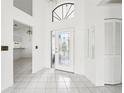 Bright and airy foyer with tiled floors and a view into the living area at 1830 E Del Webb Blvd, Sun City Center, FL 33573
