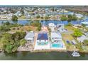 Aerial view of waterfront homes on canals with lush greenery and clear water views at 3380 Holly Springs Dr, Hernando Beach, FL 34607
