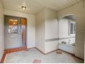 Inviting front porch with terracotta tile flooring and a gray front door at 2329 Lancaster Dr, Sun City Center, FL 33573