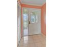 Bright entryway with a white door and tiled floor at 2329 Lancaster Dr, Sun City Center, FL 33573