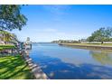 Scenic waterfront view featuring a boat dock, tranquil waterway, and lush green surroundings at 5009 W Spring Lake Dr, Tampa, FL 33629