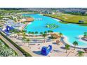 Resort-style community with large lagoon pool, water features, and sandy beach at 9358 Rally Spring Loop, Wesley Chapel, FL 33545